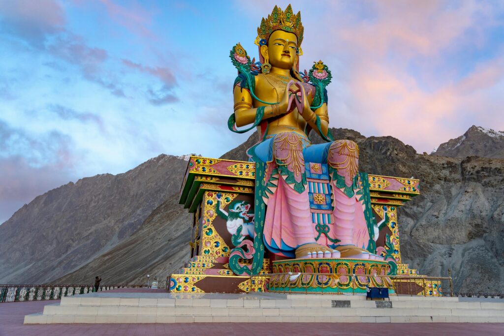 Majestic Maitreya Buddha statue at Diskit Monastery in Nubra Valley, India during sunset.